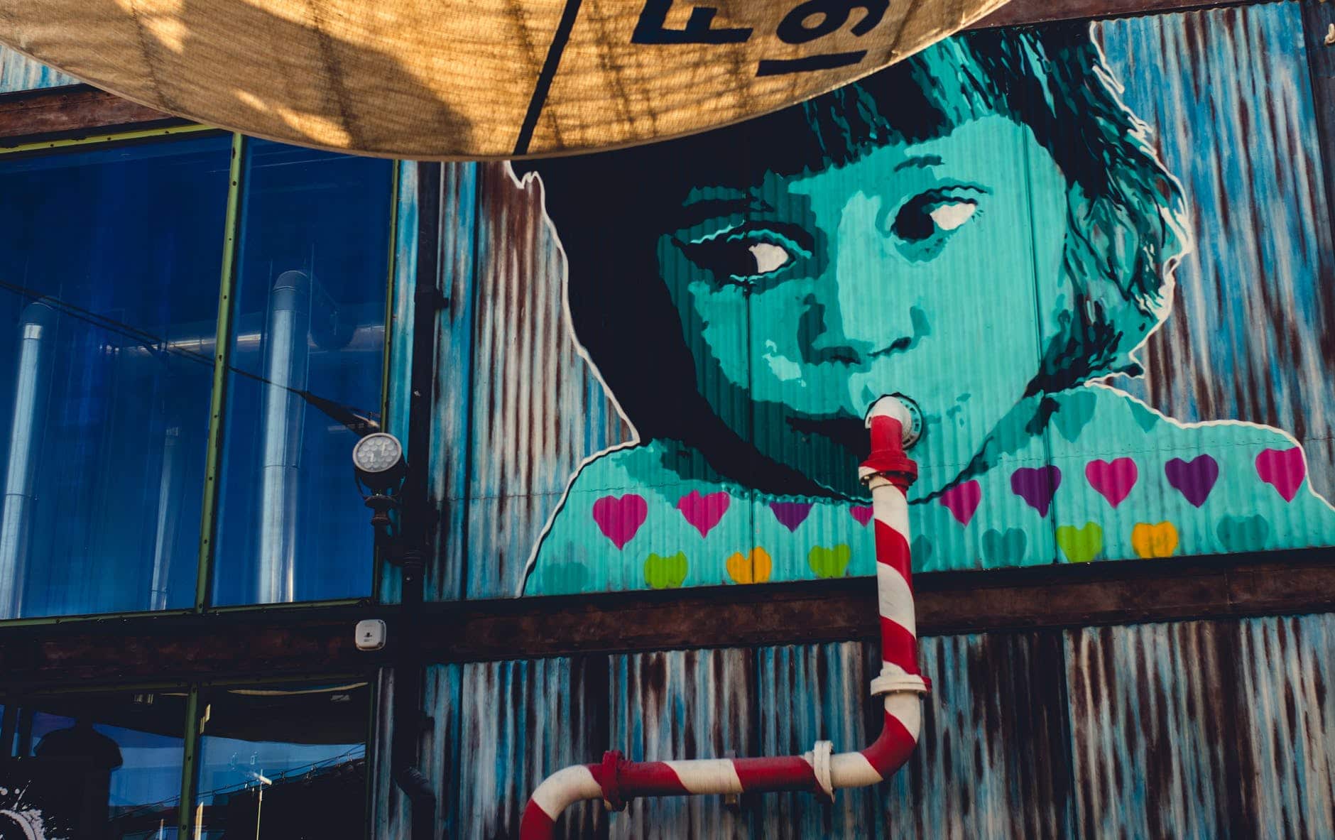 child sipping from pipe graffiti